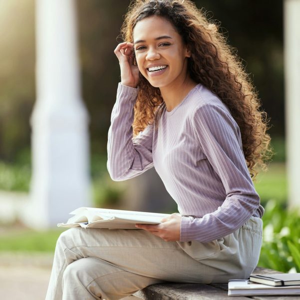 Chasing my dreams. Shot of a young female student studying in nature.