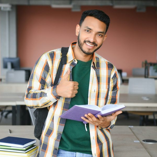 indian student with books at university