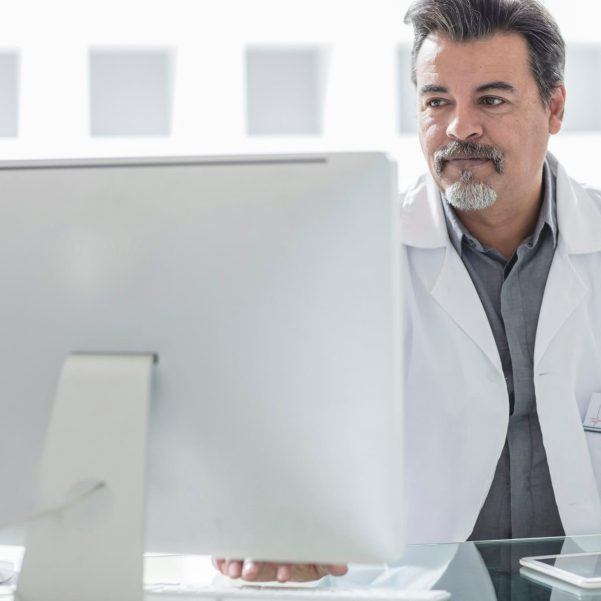 Male doctor working at computer